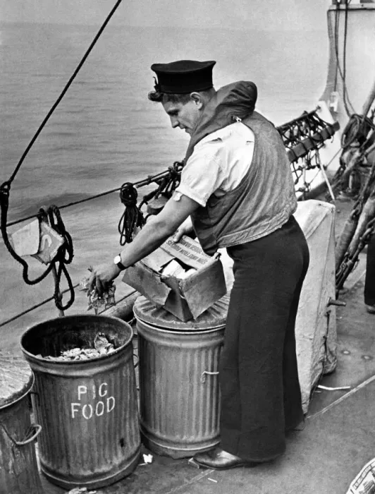 Framed Print : Nothing to wasted at sea. Seaman placing waste in salvage tins so familiar to Framed Print : Nothing to wasted at sea. Seaman placing waste in salvage tins so familiar to