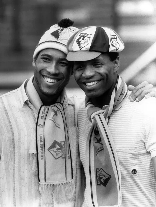 Framed Print : Watford and England duo John Barnes and Luther Blissett pose wearing club hats