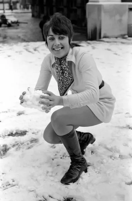 Framed Print : Weather: Winter Scenes: Woman playing in the snow making snowballs. November 1969 Z11467