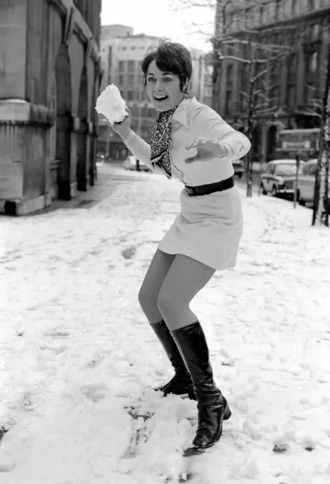 Framed Print : Weather: Winter Scenes: Woman playing in the snow making snowballs