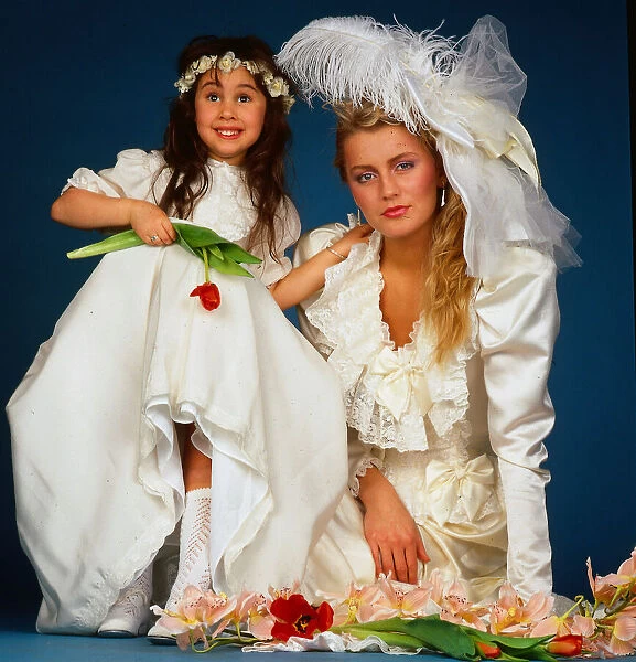 Wedding dress fashion, February 1987 model wearing wedding dress sitting ground