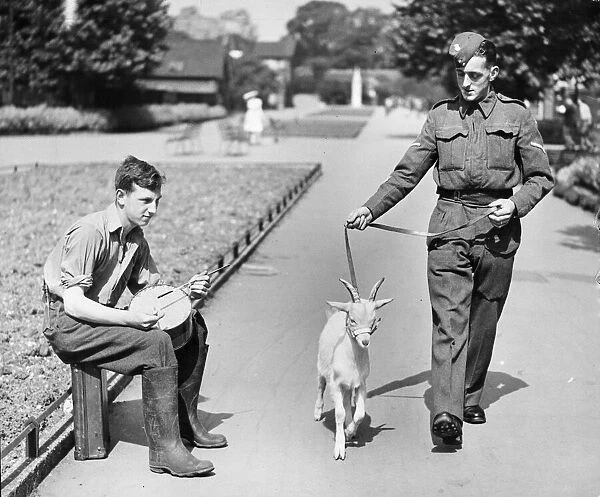 Welsh Fusiliers Regiment. A soldier takes the regiment mascot for a walk