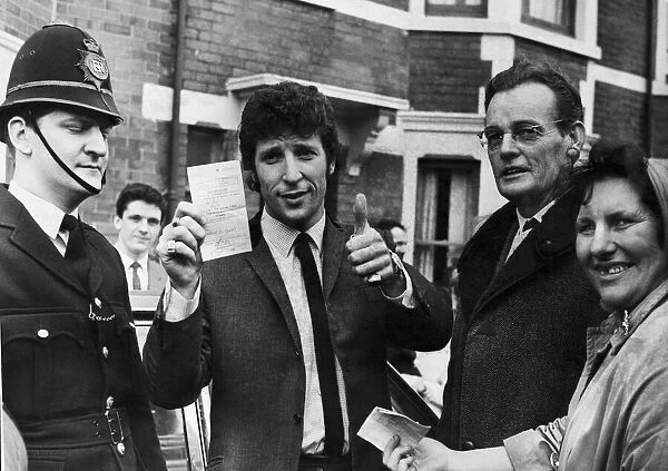 Welsh singing star Tom Jones shows his certificate after passing his driving test in