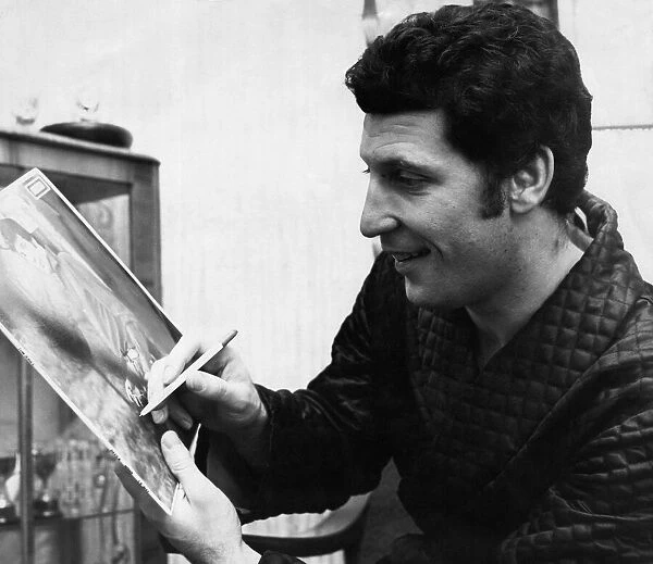 Welsh singing star Tom Jones signs a picture for a fan. 25 October 1966