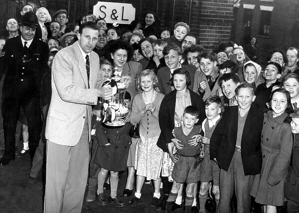 West Bromwich Albion footballer Ray Barlow presents the FA Cup to fans during a visit by