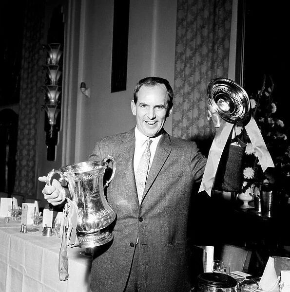 West Bromwich Albion manager Alan Ashman holding the FA Cup trophy at a dinner as