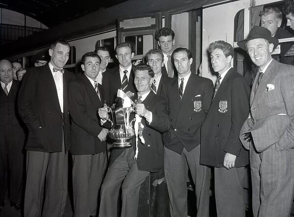 West Bromwich Albion Players with the FA Cup trophy prior to boarding the train as they