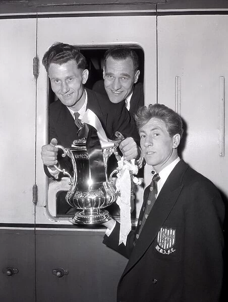 West Bromwich Albion Players on the the train with the FA Cup trophy as they leave London