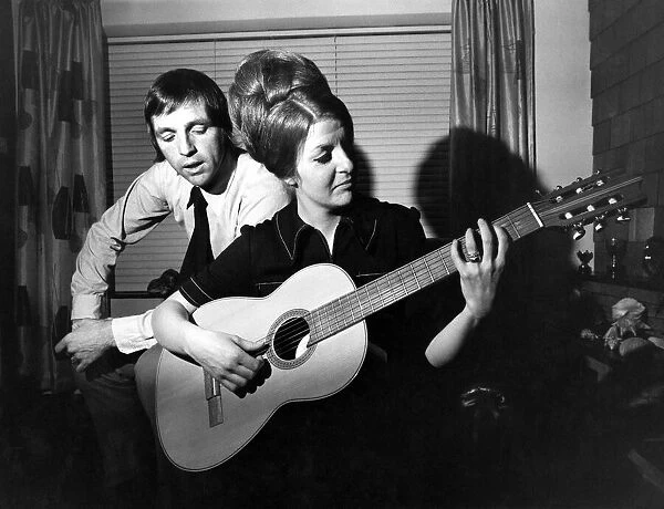 West Bromwich Albions Jeff Astle sings as his wife Laraine plays the guitar at their