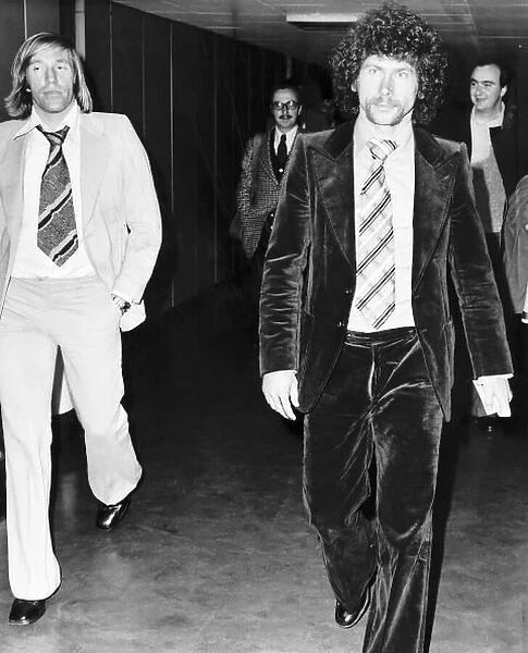 West German footballer Paul Breitner on his way through Heathrow Airport with fellow