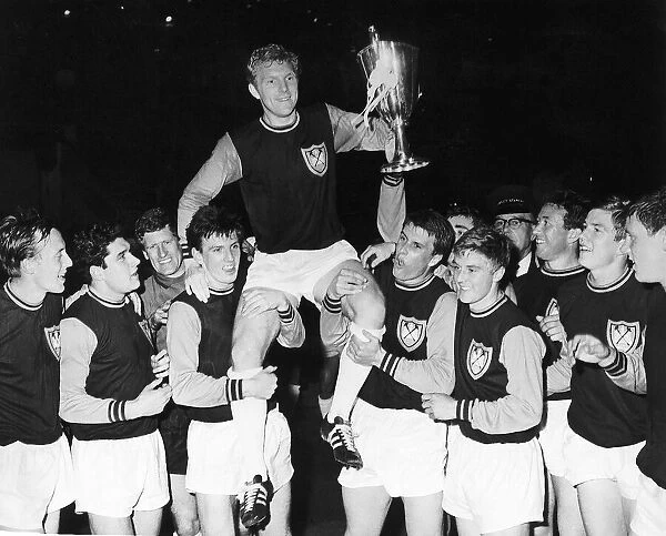 West Ham captain Bobby Moore is carried on hios teammates shoulders after winning