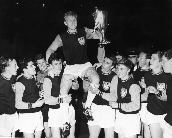 Framed Print : West Ham captain Bobby Moore is carried on hios teammates shoulders after winning Framed Print : West Ham captain Bobby Moore is carried on hios teammates shoulders after winning