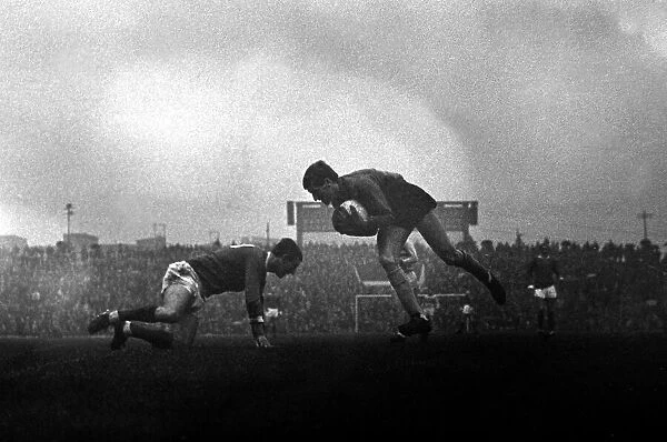 West Ham goalkeeper Jim Standen gathers a low cross as David Herd of Manchester United