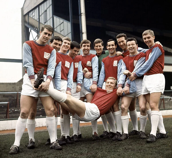 West Ham United carrying captain Bobby Moore as they pose for a team group photograph at