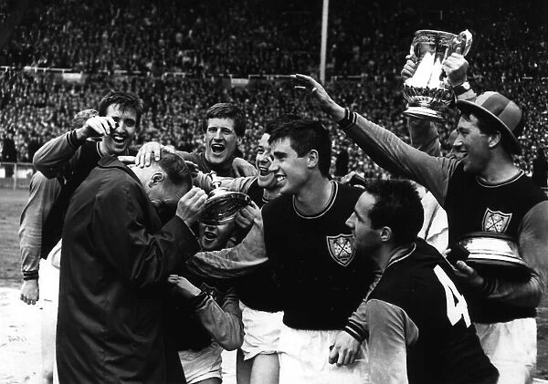 West Ham United mob their manager Ron Greenwood after they had won the FA Cup in 1964 at