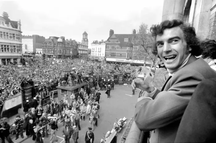 Framed Print : West Hams Trevor Brooking showing off the trophy to fans gathered below at Newham