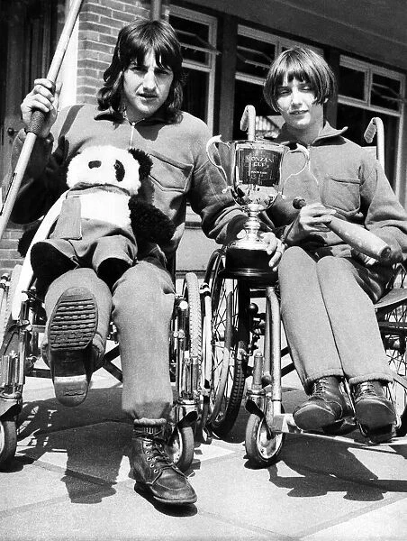 Two wheelchair champions from the Percy Hedley School in Newcastle show off the cup which