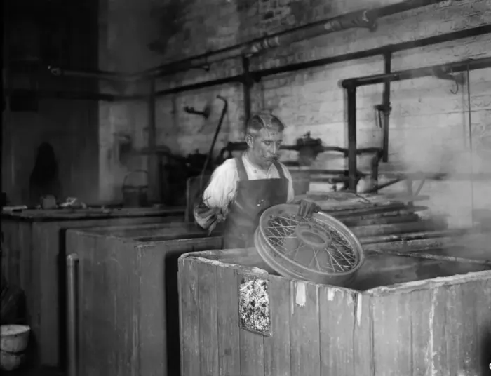 Framed Print : Wheels being dipped in chemicals in preparation for their tyres for the production line Framed Print : Wheels being dipped in chemicals in preparation for their tyres for the production line