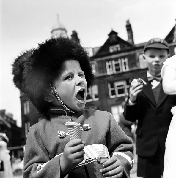 Whit Walks Manchester. June 1960 M4383-012A young boy dressed as a soldier enjoys his Ice