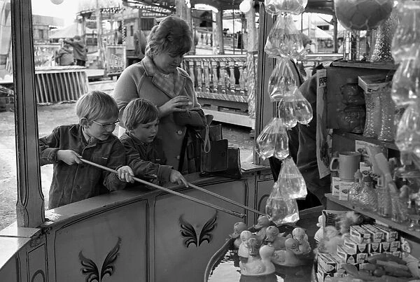 The Whitsun Fair at Hearsall Common, Coventry. These two children try their luck hooking