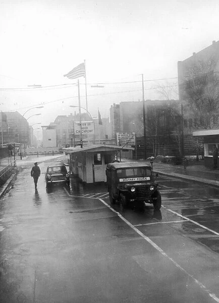 A wind swept rainy day at Checkpot Charlie on Berlin Friedrich strasse