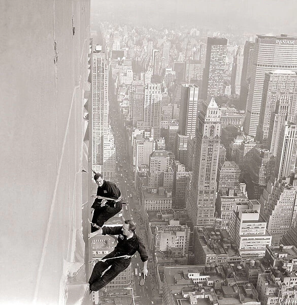 Window Cleaners a 1000 foot above the side walk cleaning the windows of the Empire State