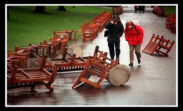 Windy Weather in Edinburgh two people brave the wind November 1999 through Princes Street