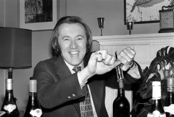 Framed Print : Wine: Mr. David Frost trying to open a bottle of wine at his home. March 1975 75-01338