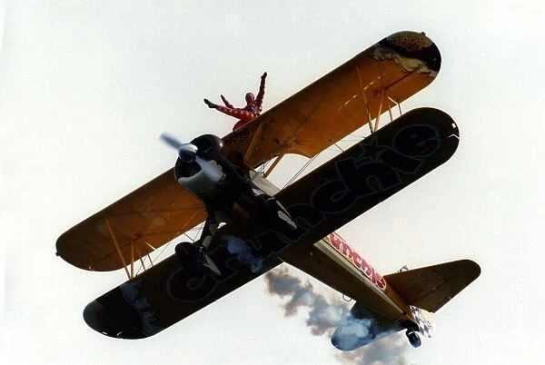 A wing walker performs on the Cadburys Crunchie Boeing-Stearman Model 75 biplane at