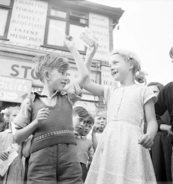Framed Print : Winners of the Ice Lollipops sucking contest hold their winning aloft