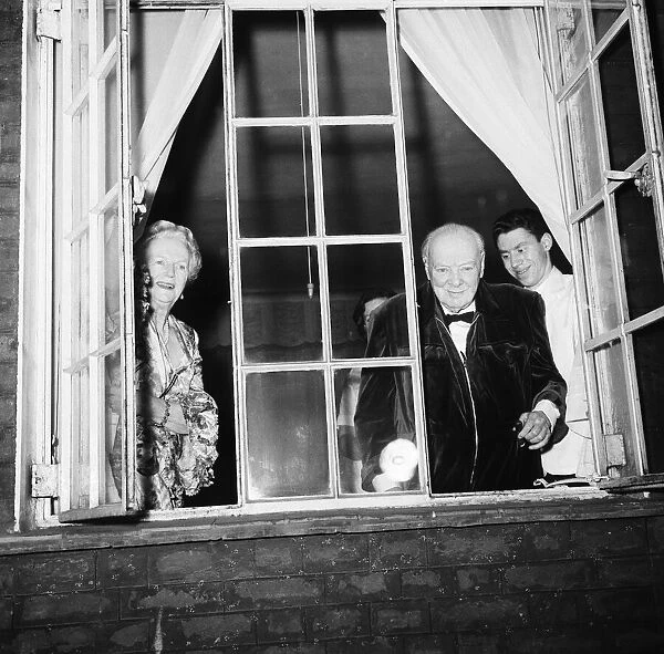 Winston Churchill acknowledges the crowd gathered below his window at his home in Hyde