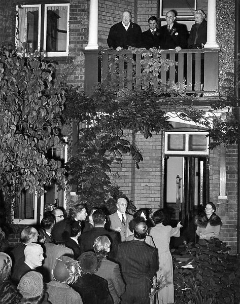 Winston Churchill makes a speech from the balcony following victory in his constituency