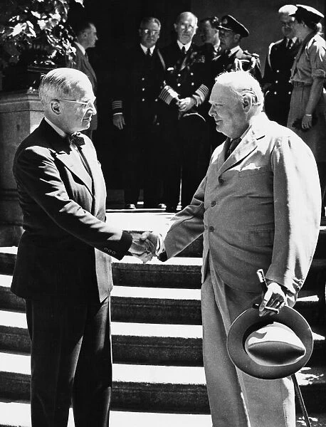 Winston Churchill and President Truman shake hands on the steps of the latter