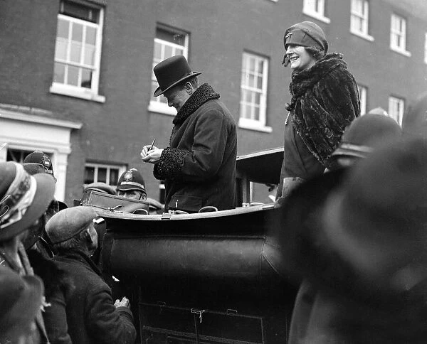 Winston Churchill is seen with his wife Clementine Churchill in an open topped car
