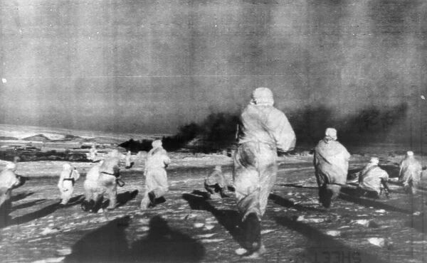 Winter clad snow soldiers of the Soviet Red Army run to the attack in a populated area