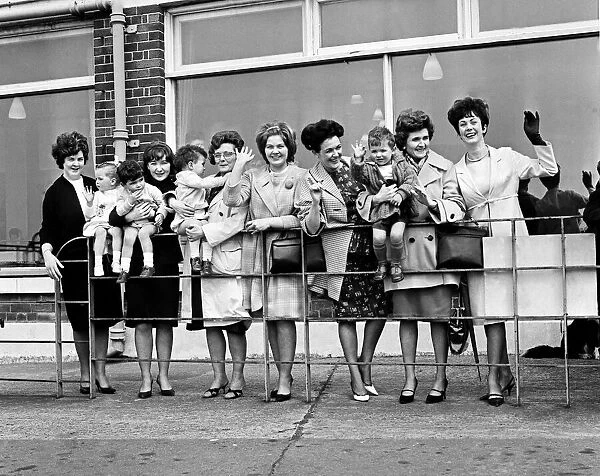 Wives and girlfriends of the Everton football team wave their last goodbye as the plane