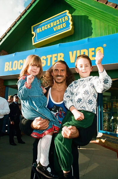 Wolf from Gladiators opening the new Blockbuster Video in Reading. 6th November 1994
