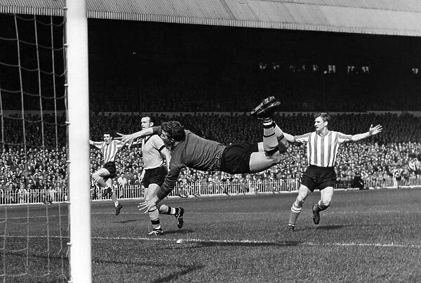 Wolverhampton Wanderers A dive by Wolves goalkeeper Davies for a shot from Hogson