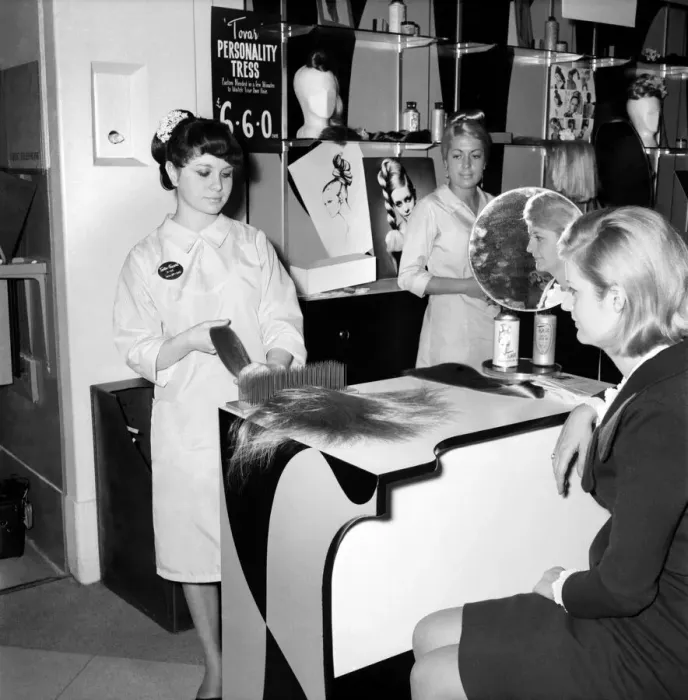 Framed Print : Woman at the beauty department of Selfridges store having a Tovar- tress attached to her