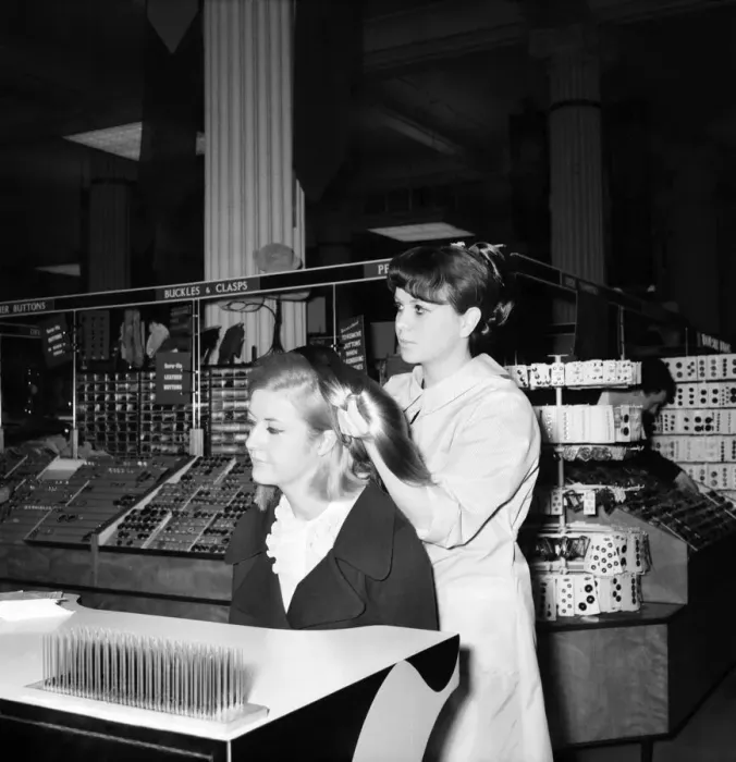 Framed Print : Woman at the beauty department of Selfridges store having a Tovar- tress attached to her