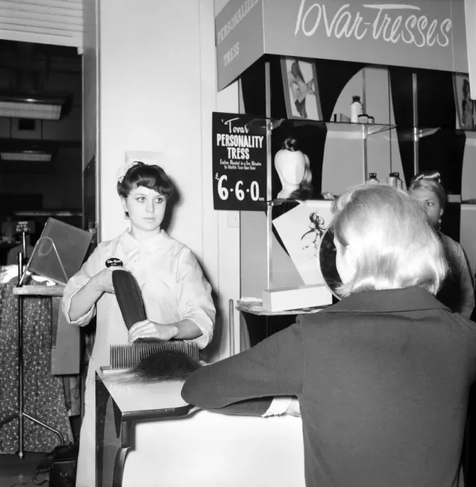 Framed Print : Woman at the beauty department of Selfridges store having a Tovar- tress attached to her