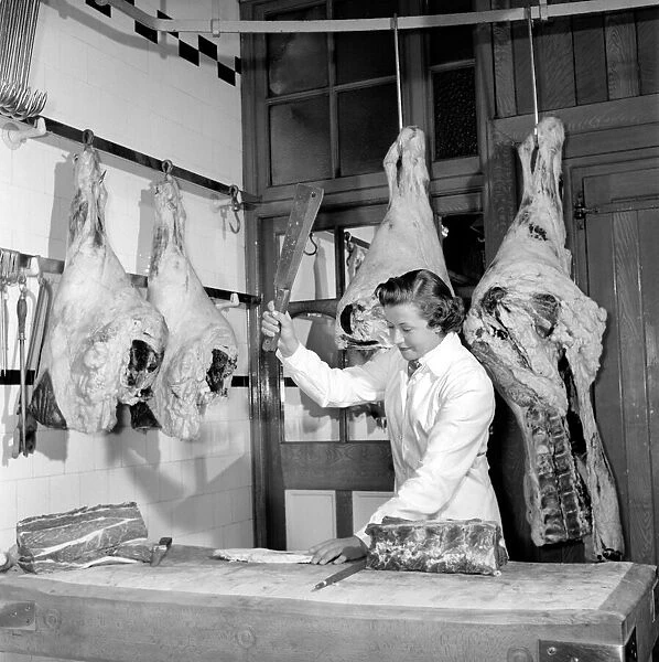 Woman butcher seen here at work. 1954