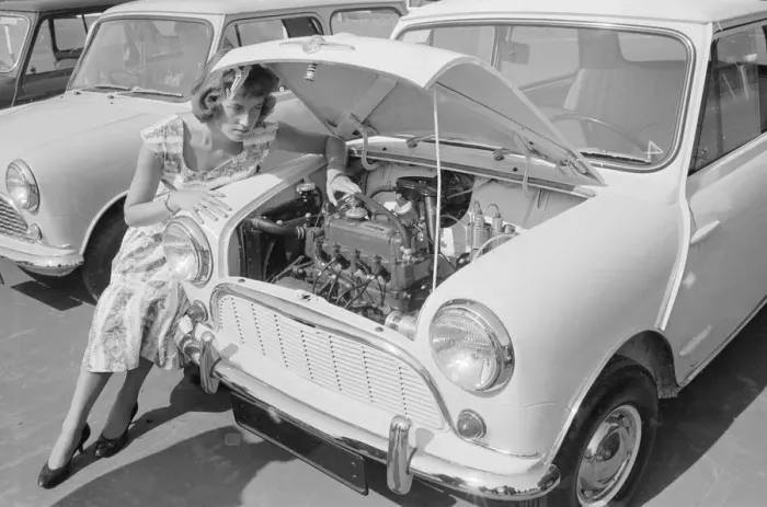 Framed Print : A woman checks the engine of one of the first mini cars designed by Alec Issigonis which