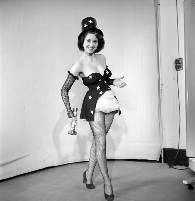 Framed Print : Woman cinema usher wearing star pattern top hat and dress holding a torch. 1959 E41 Framed Print : Woman cinema usher wearing star pattern top hat and dress holding a torch. 1959 E41