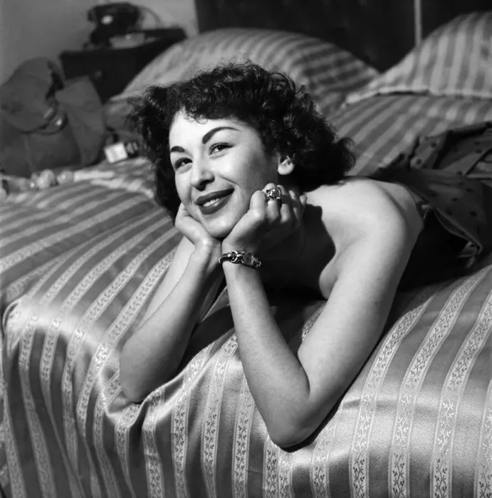 Framed Print : Woman in dress posing on bed. March 1952 C1581-002