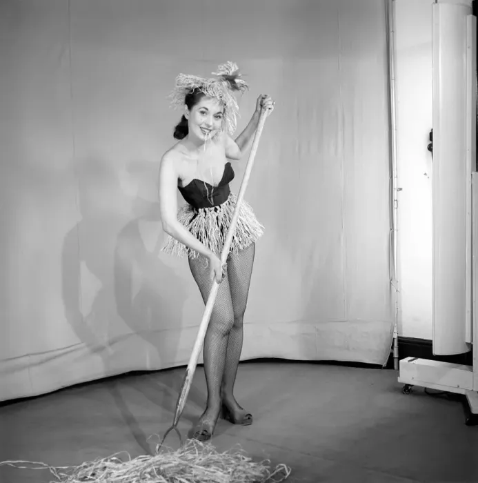 Framed Print : Woman dressed in grass skirt as girl Friday. 1959