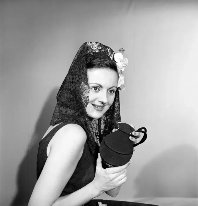 Framed Print : Woman dressed in the Spanish style holding compact. 1957 Framed Print : Woman dressed in the Spanish style holding compact. 1957