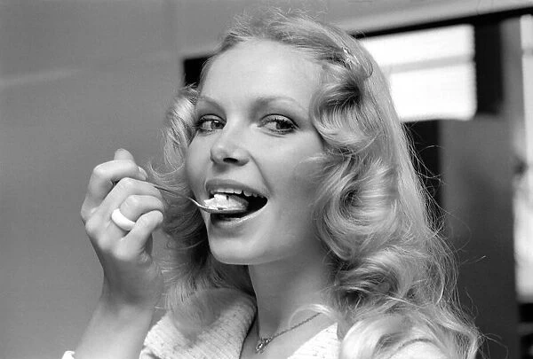 Woman eating from a teaspoon April 1975 75-2138-001