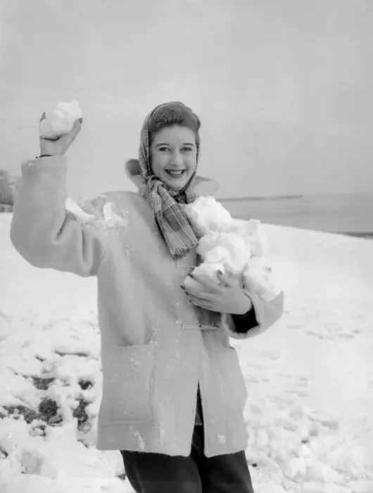 Framed Print : A woman having a snowball fight with her friend on Hastings beach. 8th March 1955 Framed Print : A woman having a snowball fight with her friend on Hastings beach. 8th March 1955