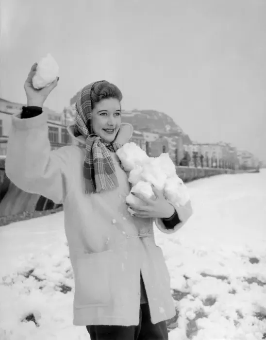 Framed Print : A woman having a snowball fight with her friend on Hastings beach. 8th March 1955 Framed Print : A woman having a snowball fight with her friend on Hastings beach. 8th March 1955